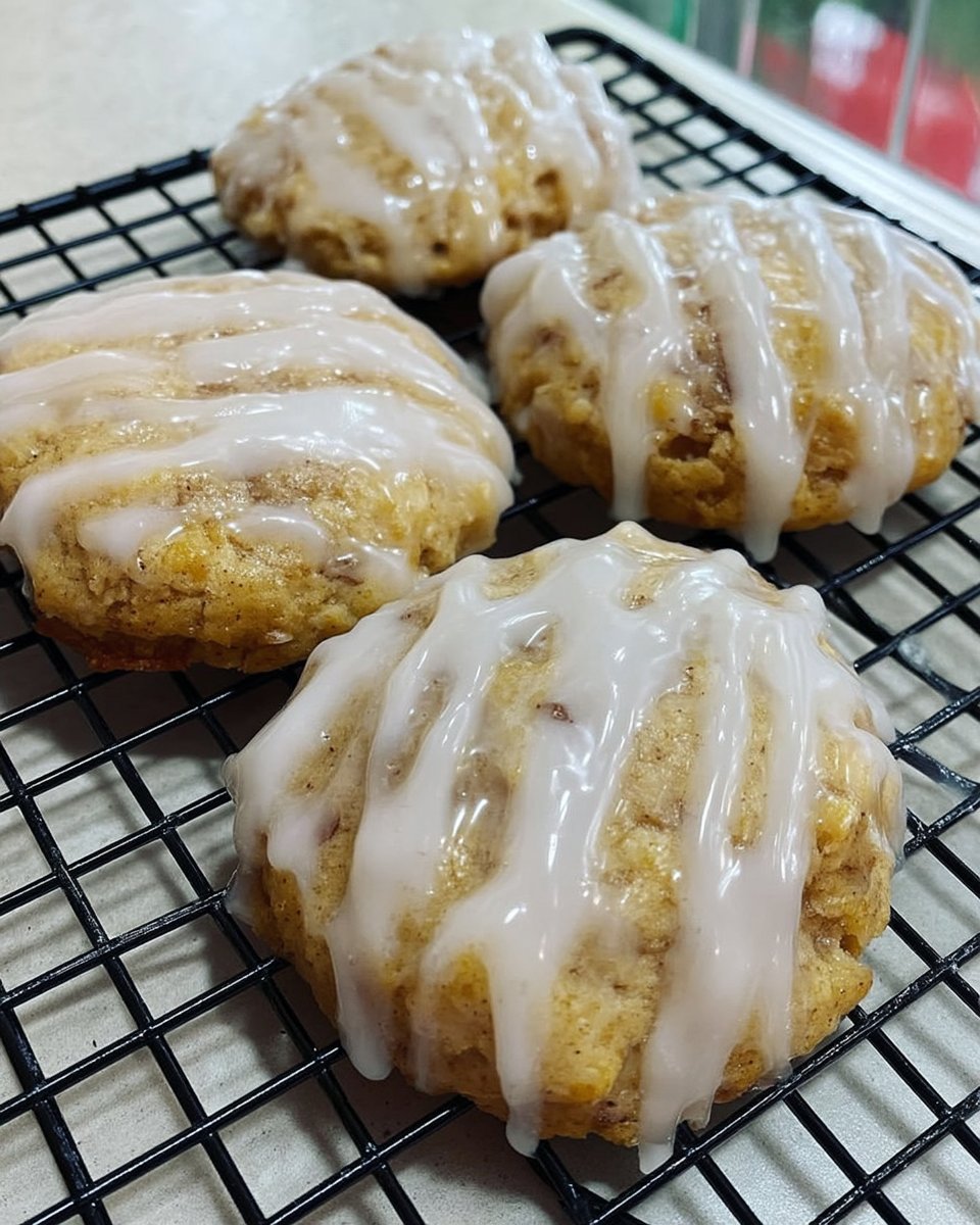 Lemon glazed cookies served on a decorative plate with a cup of tea