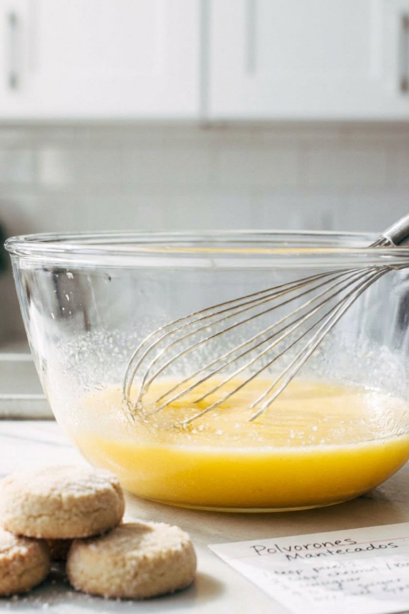 Polvorones dough being scooped onto a baking sheet