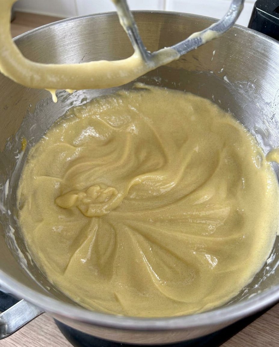 Hands pressing a thumbprint into cookie dough balls