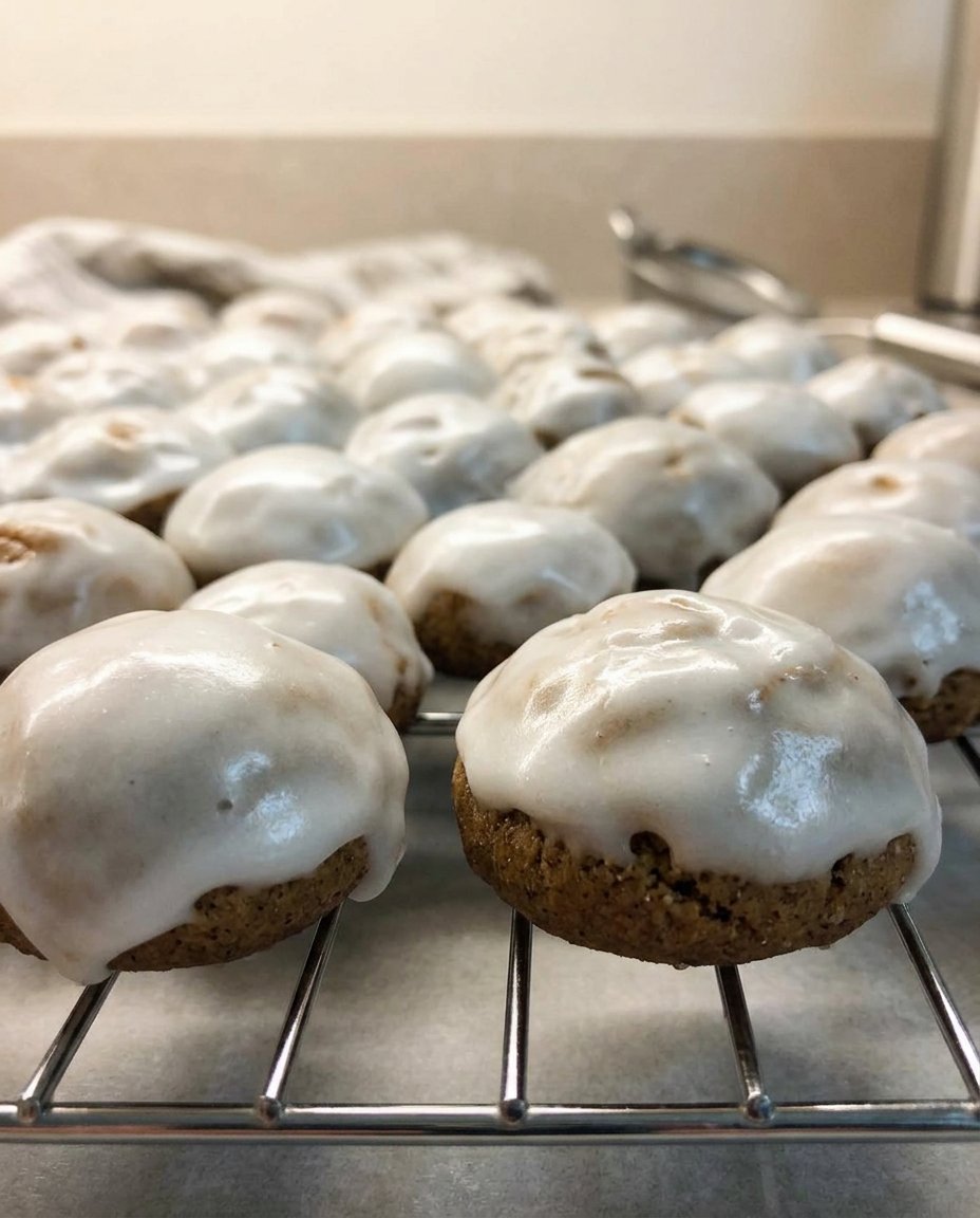 A plate of pfeffernusse cookies served with a cup of herbal tea.