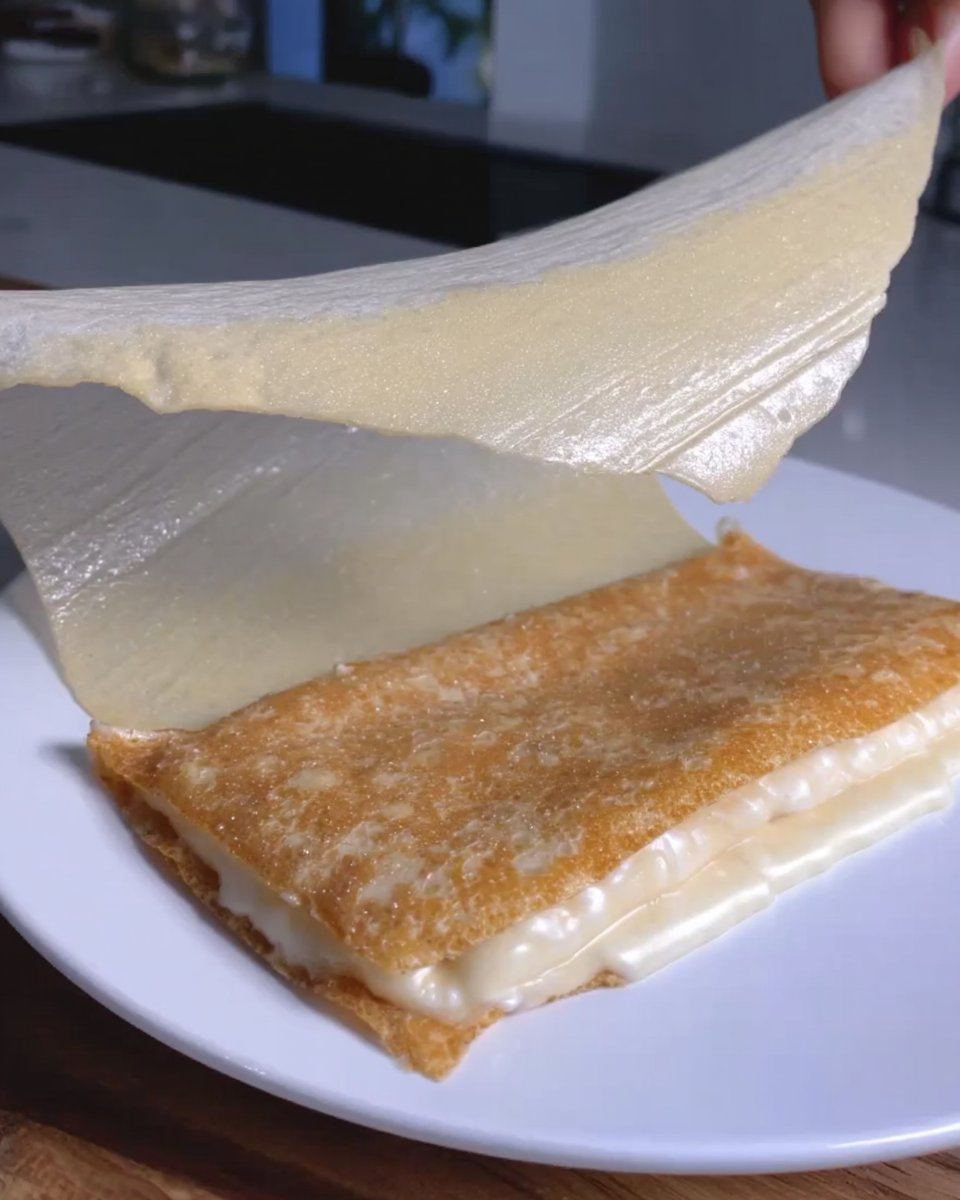 Curving a hot tuile cookie over a rolling pin