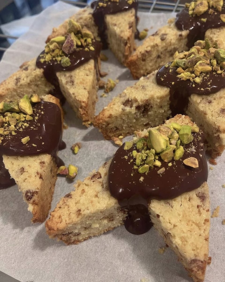 Chocolate dipped shortbread cookies stacked inside a vintage glass jar