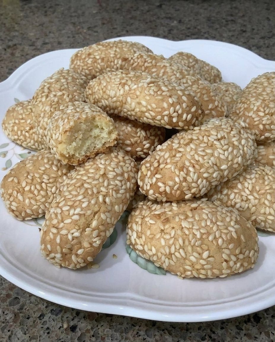 A jar filled with golden Sicilian sesame cookies called Biscotti Regia.