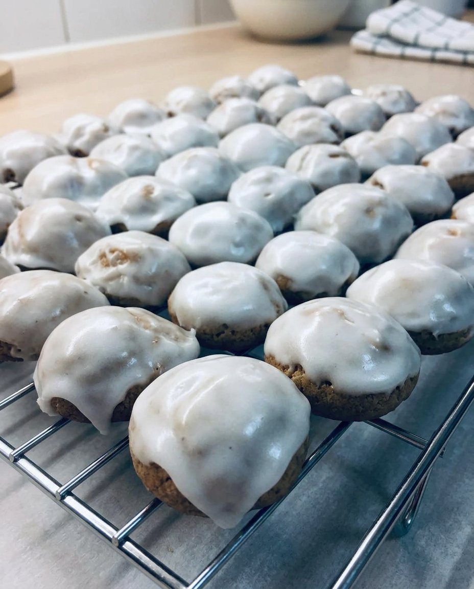 A jar filled with soft and chewy pfeffernusse cookies glazed in white sugar.