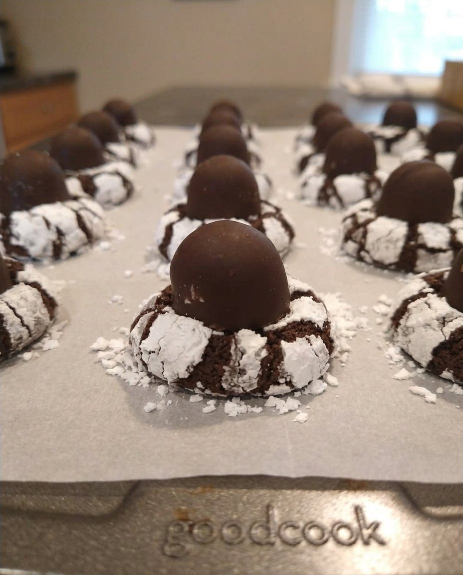 Old-fashioned cherry cordial cookies with chocolate filling and white drizzle on a wire rack
