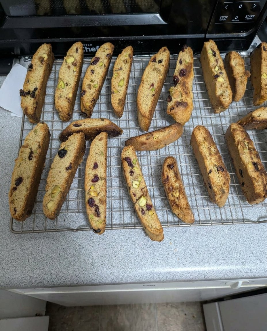 Crunchy cranberry pistachio biscotti on a cooling rack.